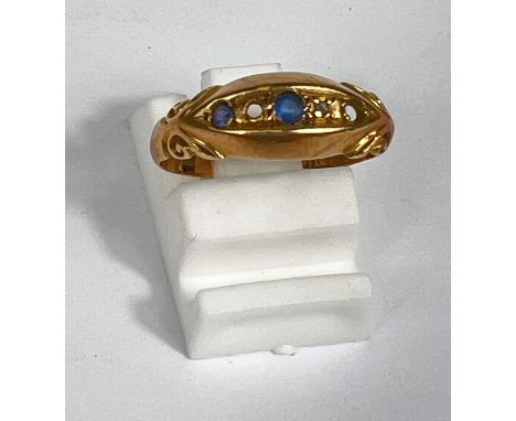 An 18 carat gypsy style ring set with 5 blue and clear stones, 2 gm, size H-J, (2 stones missing) 