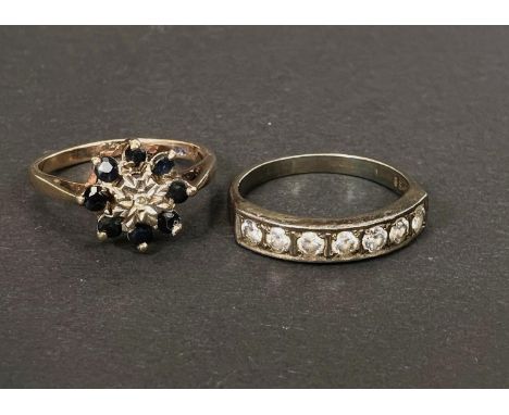 A 9 carat hallmarked gold dress ring with illusion set diamond and sapphires in flowerhead formation, size H, 2gm; a 4 stone 