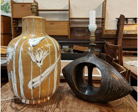 A modernist composition bronzed effect table lamp with oval shaped body and pierced centre; a large Chinese style ceramic tab