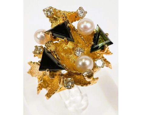 An unusual 18 carat hallmarked gold large modernist / architectural style ring with raised and layered stylized leaves, 3 tri