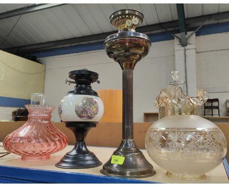 An oil lamp with Corinthian column and pink glass shade; another with ceramic reservoir and brown shade; a Carltonware salad 