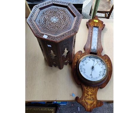 An inlaid oak case aneroid barometer and a small Middle Eastern occasional table 