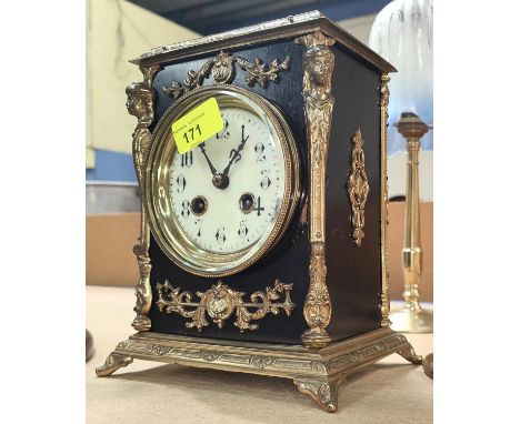 An ornate 19th century gilt metal and black mantle clock with striking French drum movement, ht. 22cm 