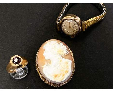 A yellow metal ring set garnet, 2.5gm; a ladies 9 carat gold wristwatch on expanding bracelet; a female head cameo in&nbsp;ye