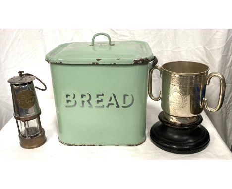 A miner's safety lamp; a green enamel bread bin; a 19th century silver plated trophy cup 