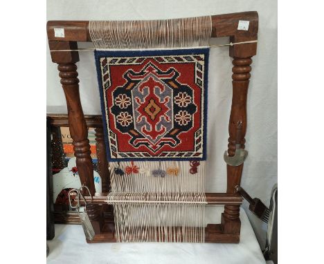 A display item depicting a traditional loom set up with small tools attached, ht 55 x 40cm 