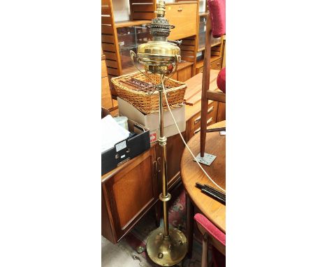 A Victorian standard oil lamp, turned brass in the Art Nouveau style on circular base and triple feet (converted) 
