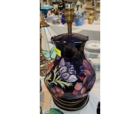 A Moorcroft large, Clematis lamp with blue ground and wooden base, ht. 36cm 