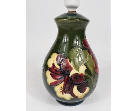 A Moorcroft green ground table lamp, red and green Hibiscus flower decoration, height 19cm 