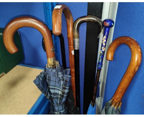 A horn handled and ebonised walking stick with silver mounts, an enamelled handled parasol, other sticks and parasols 