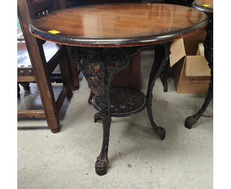 A 19th century cast iron based 'Britannia' circular pub table, with shelf bellow, diameter 69cm 