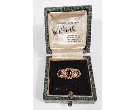 An 18ct hallmarked gold gypsy style dress ring set with 3 rubies with 2 small diamonds and 2 small diamonds in between, size 