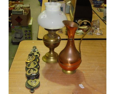 Vintage horse brasses, paraffin lamp and copper ewer