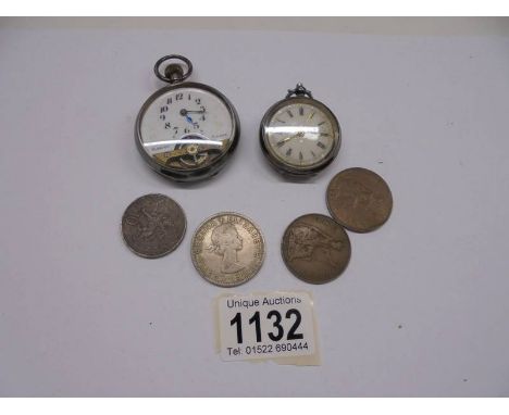 A lady's silver fob watch, a pocket watch and four coins. 