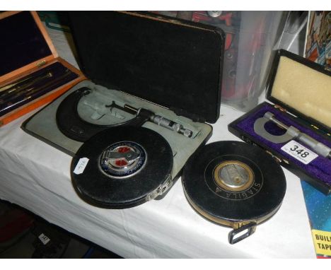 A selection of measuring tools including micrometers and measuring tapes, etc. 