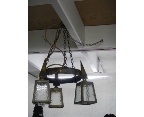 An arts and crafts brass triple lantern ceiling light. COLLECT ONLY.