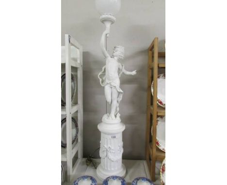 A floor standing cherub lamp on plinth, COLLECT ONLY.Bottom base to top of shade 47"This is heavy resin