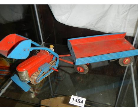 A tinplate Gescha B-720 Caterpillar tractor with trailer, made in Western Germany.