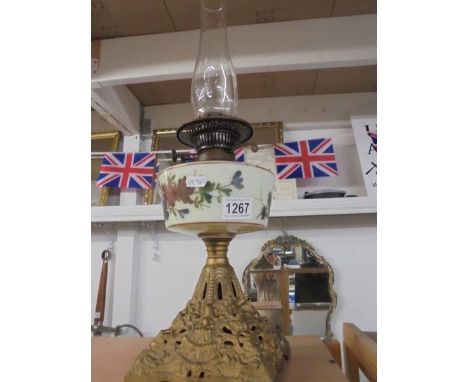 A Victorian oil lamp on metal base with hand painted font and complete with chimney. 