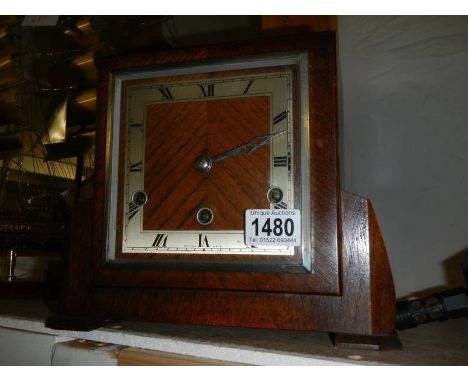 A 1930's oak mantel clock with three key holes.