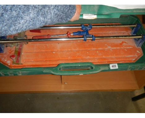A large cased tile cutter. 