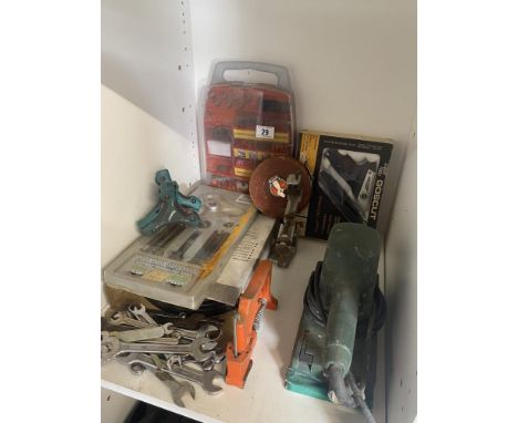 A lot of spanners, wheel puller, allen keys, metal sheet cutter, twist drill sharpening guide, sander and chesterman tape.