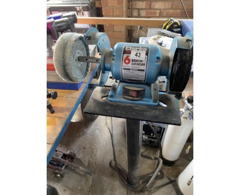 A Clarke 6" bench grinder with attachments.