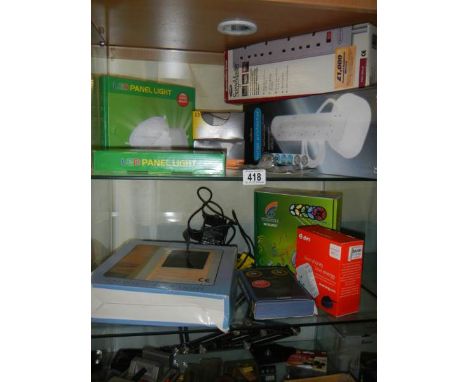 Two shelves of assorted light fittings. 