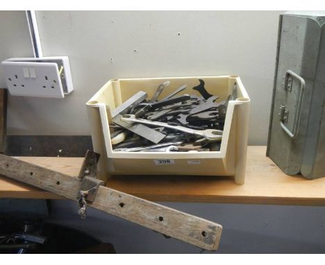 A box of hand tools, a tool box and clamp. 