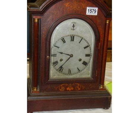 A Victorian mahogany inlaid chiming mantel clock in working order.Height 16.5"Width at base 12"Depth 6.75"
