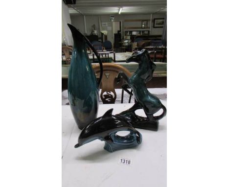 A Poole Pottery dolphin and two other unmarked pottery items. 