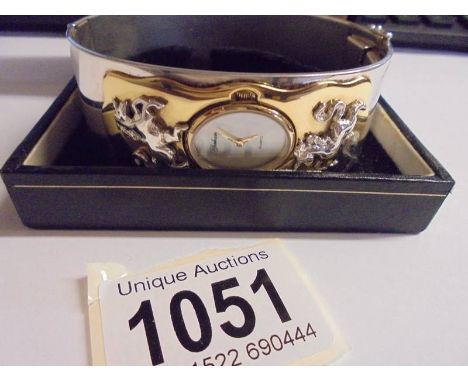 A Gorham unicorn bangle watch with mother of pearl face with certificate from Brooks/Bentley. 
