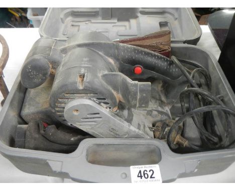 A cased belt sander. 