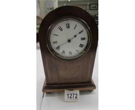 A mahogany inlaid mantel clock. 