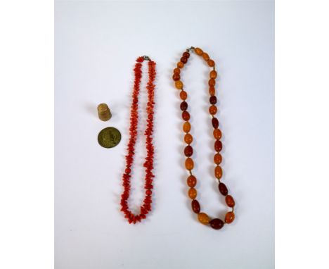 An amber bead necklace, together with a stick coral necklace, a faceted graduated French jet necklace, a graduated jade neckl