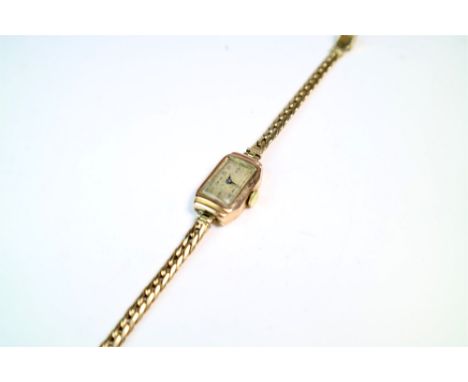 Two 9ct gold ladies wristwatches. Comprising of: one Tissot time only wristwatch with link and pin bracelet with security cha