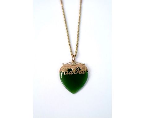 A yellow metal mounted heart shaped jade pendant, suspended from yellow metal chain, stamped '9'