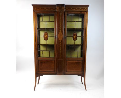 An Edwardian mahogany and inlaid display cabinet in Adam Revival style the bevelled top above a swag inlaid frieze and bow fr