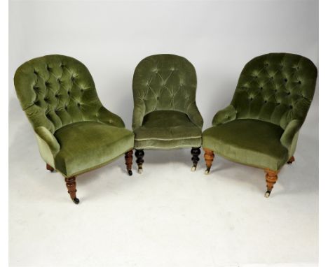 Three Victorian ladies' parlour chairs, each later covered in green button back Dralon, each raised on ring turned front legs
