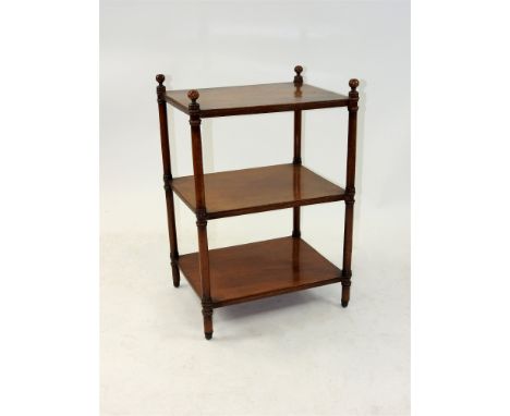 A Victorian mahogany three tier whatnot of rectangular outline, each shelf spaced by a ringturned pilaster, the legs terminat