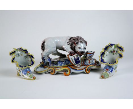 A pair of Mosanic faience shoe vases 19th century, painted in polychrome with flowers, signed to the base, 12.5cm high (one r