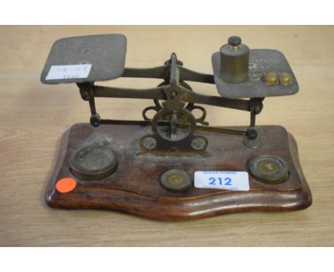 A set of early 20th century postal scales and weights, Width 17cm