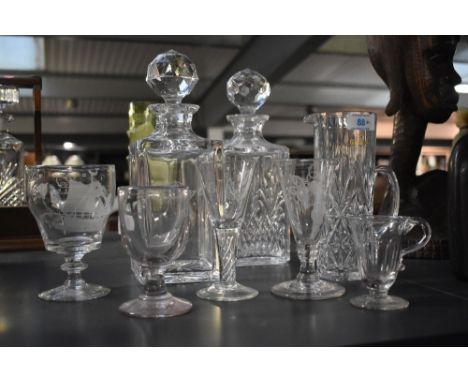 A pair of cut crystal decanters with the initials J.M.M, h26cm, sold together with a selection of firing glasses engraved dep