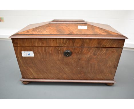 A 19th century tea caddy of sarcophagus form, supported on bun feet, the interior having two lidded compartments and glass mi