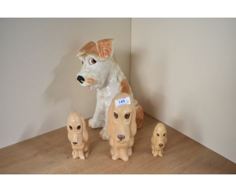 A large Sylvac Terrier Dog number 1380 measures 29cm tall sold together with three sad-faced beige Spaniel's number's 2950, 2