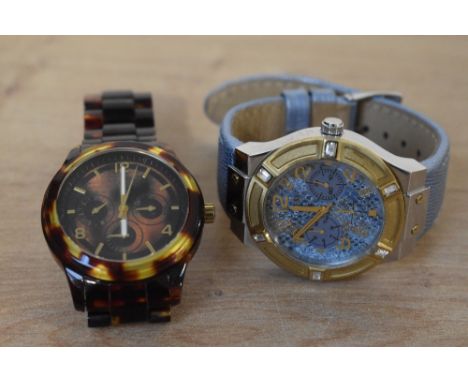 Two Guess wristwatches, one having a blue snake print dial with two subsidiary dials on a metallic blue leather strap, the ot