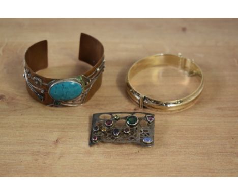 A Paula Bolton copper and turquoise cuff bangle, having blossom decoration with bezel set turquoise, along with a silver Paul