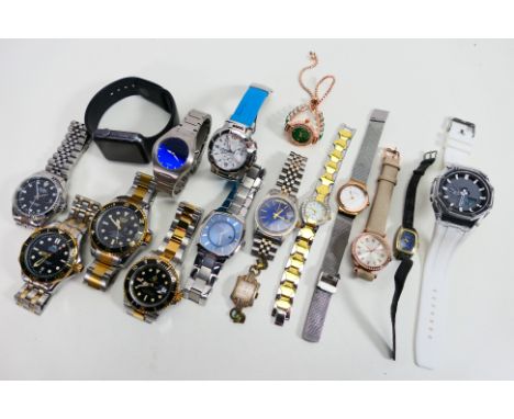A collection of watches to include an Apple Smartwatch, a Tissot Trace, Skagen Denmark, a Fossil Big Tic among similar others