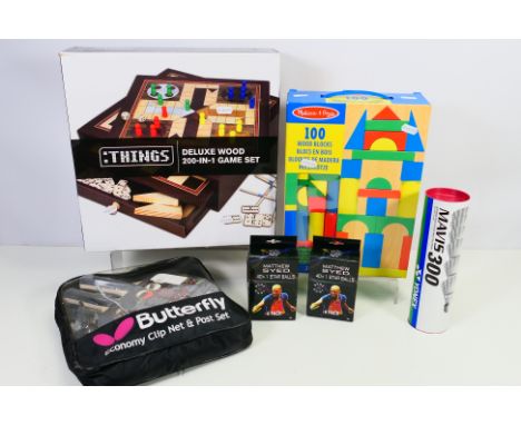 A boxed Deluxe Wood 200 In 1 Game Set, Melissa & Doug 10 piece wood block set and a quantity of badminton and table tennis it
