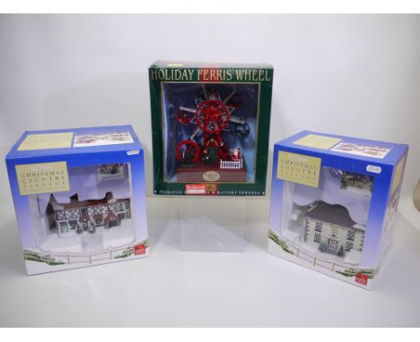 Lot to include two boxed Noma Christmas Country Village Porcelain Collection model buildings and a boxed Maisto Holiday Ferri